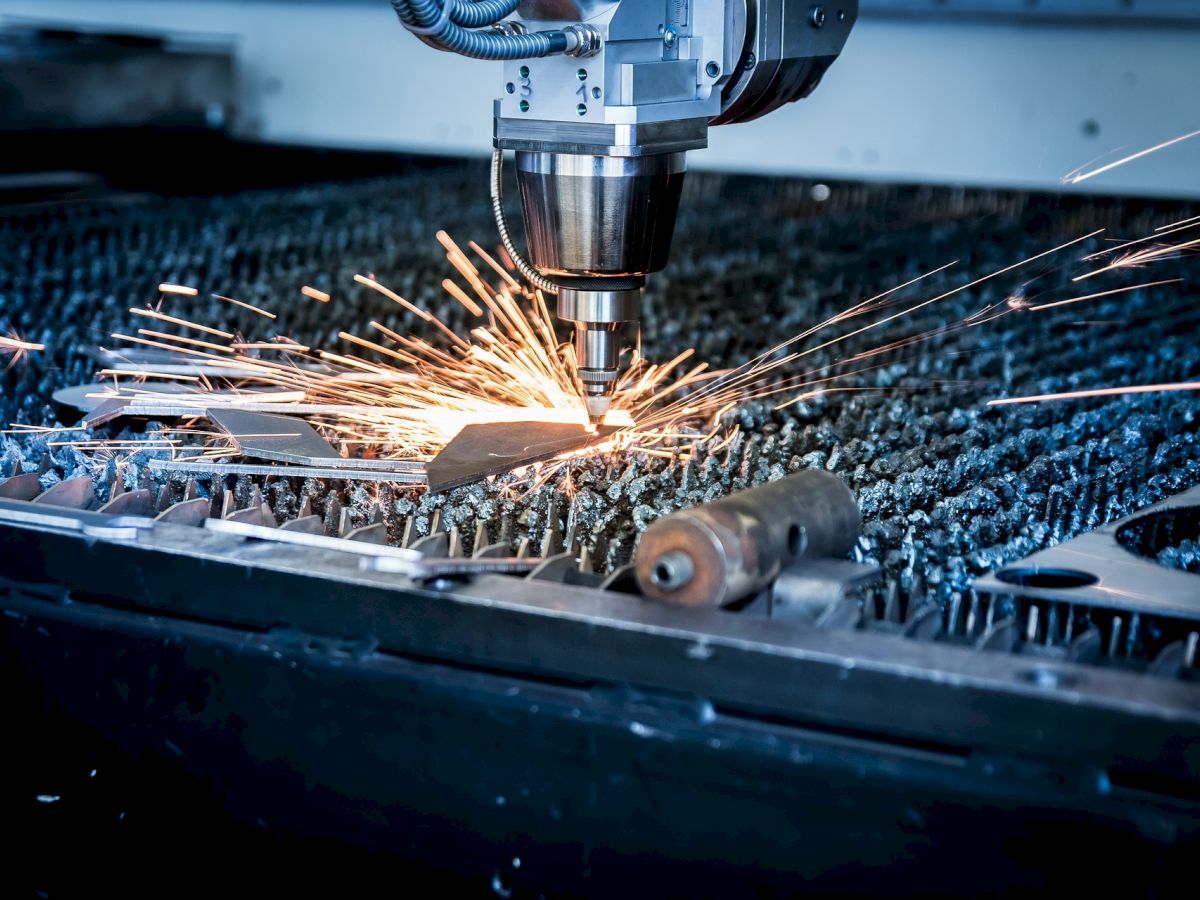 A CNC machine cutting metal with sparks flying suggests precision engineering and manufacturing.